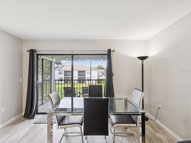 214 Meadow Ln Unit 214, Oldsmar, FL 34677 - dining area with wood finished floors and baseboards