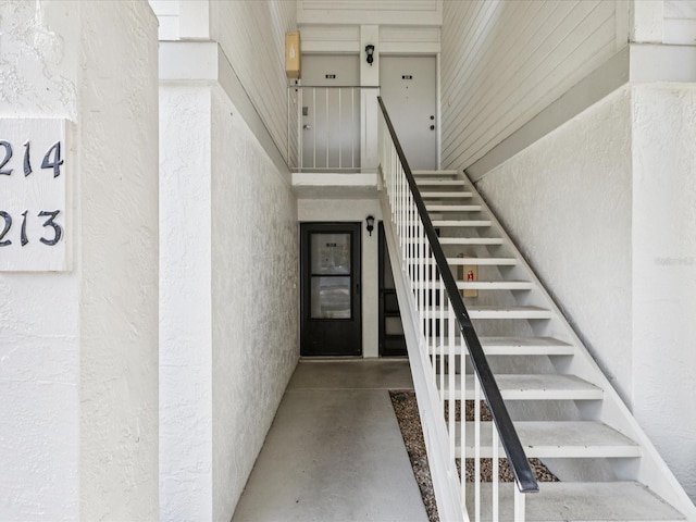214 Meadow Ln Unit 214, Oldsmar, FL 34677 - stairs featuring a textured wall and finished concrete flooring