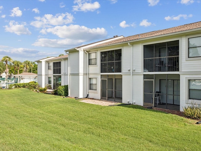 214 Meadow Ln Unit 214, Oldsmar, FL 34677 - rear view of house featuring a yard
