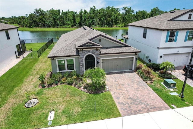 12646 Oak Hill Way, Parrish, FL 34219 - view of front of property featuring stucco siding, a water view, decorative driveway, and an attached garage