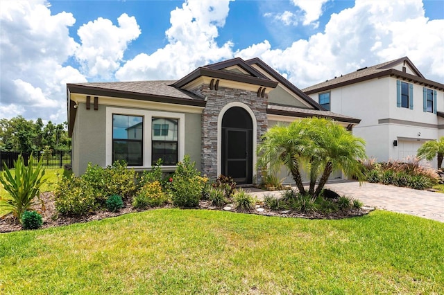 12646 Oak Hill Way, Parrish, FL 34219 - view of front of house featuring stone siding, driveway, stucco siding, and a garage