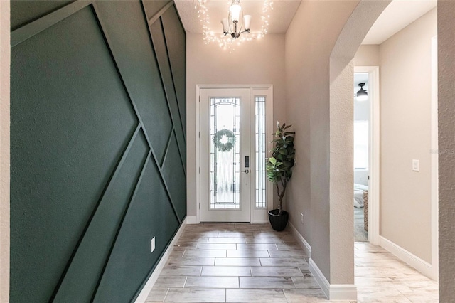 12646 Oak Hill Way, Parrish, FL 34219 - foyer entrance with arched walkways, light wood-style flooring, and a chandelier