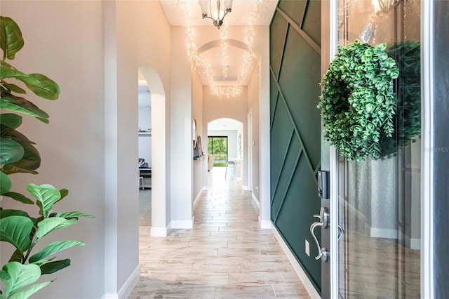 12646 Oak Hill Way, Parrish, FL 34219 - corridor featuring arched walkways and a chandelier