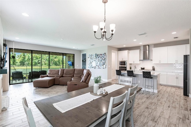 12646 Oak Hill Way, Parrish, FL 34219 - dining room featuring a chandelier, light wood-style flooring, and recessed lighting