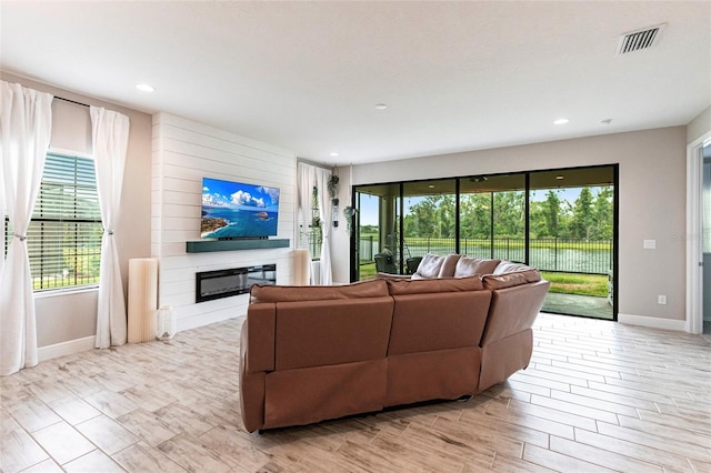 12646 Oak Hill Way, Parrish, FL 34219 - living room featuring a glass covered fireplace, healthy amount of natural light, and recessed lighting