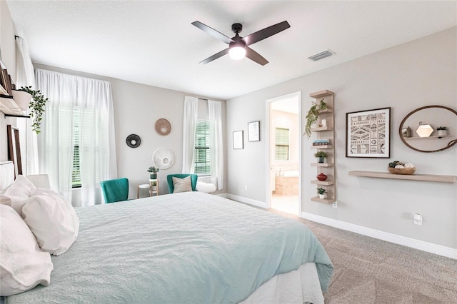 12646 Oak Hill Way, Parrish, FL 34219 - carpeted bedroom featuring connected bathroom and ceiling fan