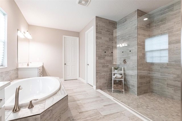 12646 Oak Hill Way, Parrish, FL 34219 - full bath featuring a garden tub, vanity, and walk in shower
