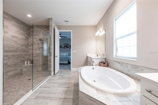 12646 Oak Hill Way, Parrish, FL 34219 - ensuite bathroom featuring vanity, a garden tub, a shower stall, and recessed lighting