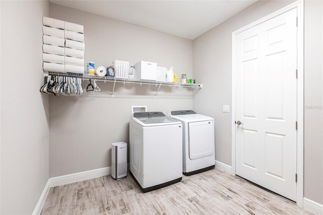 12646 Oak Hill Way, Parrish, FL 34219 - laundry room featuring washer and clothes dryer and light wood-style floors