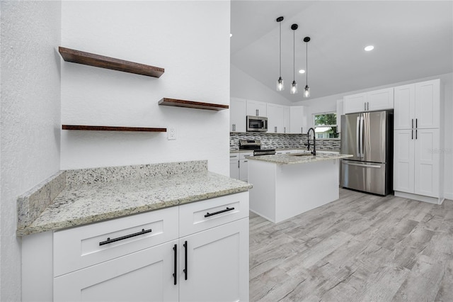 2859 38th Ave N, Saint Petersburg, FL 33713 - kitchen with open shelves, appliances with stainless steel finishes, light wood-type flooring, a center island with sink, and white cabinets