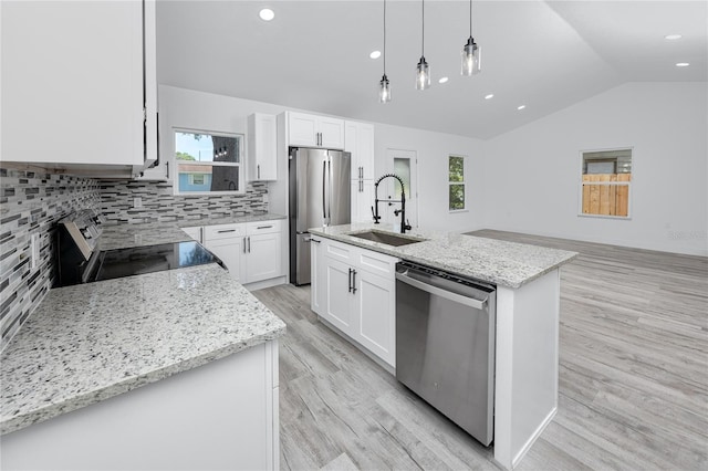 2859 38th Ave N, Saint Petersburg, FL 33713 - kitchen featuring appliances with stainless steel finishes, lofted ceiling, light wood-style floors, decorative light fixtures, and tasteful backsplash