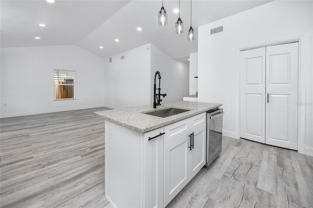 2859 38th Ave N, Saint Petersburg, FL 33713 - kitchen featuring stainless steel dishwasher, light wood-type flooring, hanging light fixtures, lofted ceiling, and light stone countertops