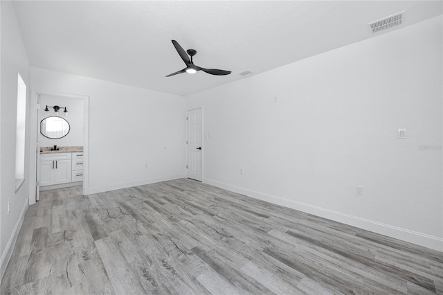 2859 38th Ave N, Saint Petersburg, FL 33713 - unfurnished living room featuring ceiling fan and light wood-style floors