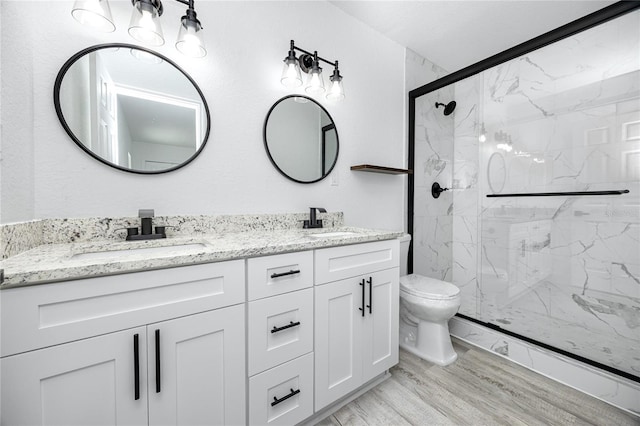 2859 38th Ave N, Saint Petersburg, FL 33713 - bathroom featuring a marble finish shower, double vanity, and wood finished floors