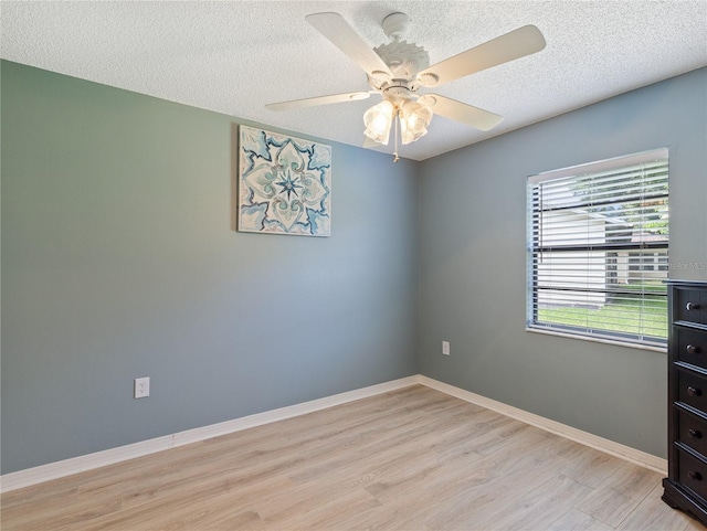 37147 Foxrun Pl, Zephyrhills, FL 33542 - empty room with light wood finished floors, a textured ceiling, and a ceiling fan