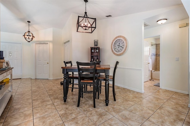 37147 Foxrun Pl, Zephyrhills, FL 33542 - dining area with a chandelier and light tile patterned flooring