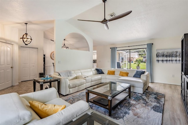 37147 Foxrun Pl, Zephyrhills, FL 33542 - living room featuring lofted ceiling, a ceiling fan, light wood-style flooring, and a textured ceiling