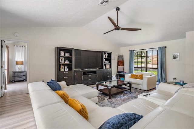 37147 Foxrun Pl, Zephyrhills, FL 33542 - living room with vaulted ceiling, ceiling fan, and light wood-style flooring