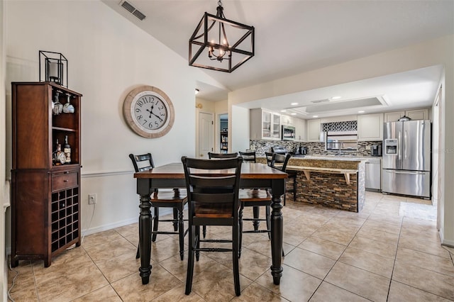 37147 Foxrun Pl, Zephyrhills, FL 33542 - dining room featuring light tile patterned floors, a tray ceiling, and lofted ceiling