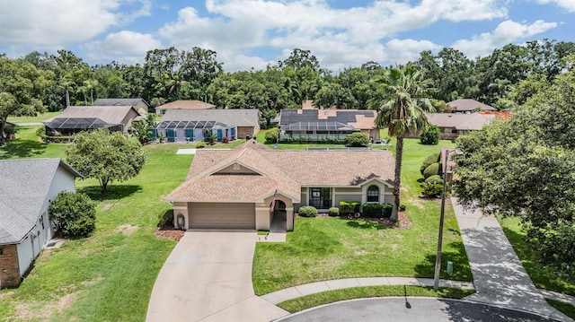 37147 Foxrun Pl, Zephyrhills, FL 33542 - view of front of home with concrete driveway, a garage, a residential view, stucco siding, and a front yard