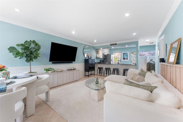 2809 W Platt St Unit 6, Tampa, FL 33609 - living area with crown molding, light tile patterned floors, recessed lighting, wainscoting, and light colored carpet