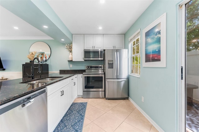 2809 W Platt St Unit 6, Tampa, FL 33609 - kitchen featuring stainless steel appliances, dark stone countertops, white cabinetry, healthy amount of natural light, and recessed lighting