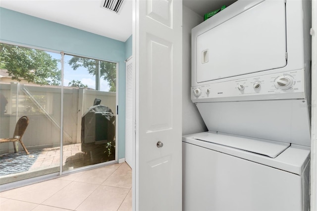 2809 W Platt St Unit 6, Tampa, FL 33609 - laundry area featuring stacked washing machine and dryer and light tile patterned floors