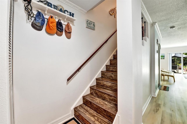 2700 Bayshore Blvd Unit 544, Dunedin, FL 34698 - stairs with a textured ceiling and wood finished floors