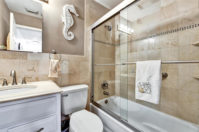 2700 Bayshore Blvd Unit 544, Dunedin, FL 34698 - bathroom with vanity, enclosed tub / shower combo, and tile walls