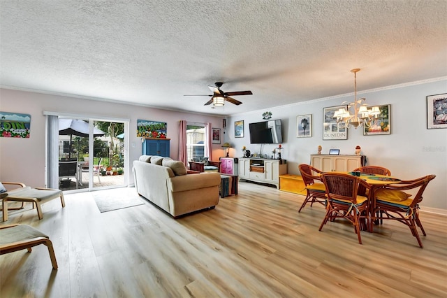 2700 Bayshore Blvd Unit 544, Dunedin, FL 34698 - living room featuring light wood finished floors, a chandelier, a textured ceiling, crown molding, and ceiling fan