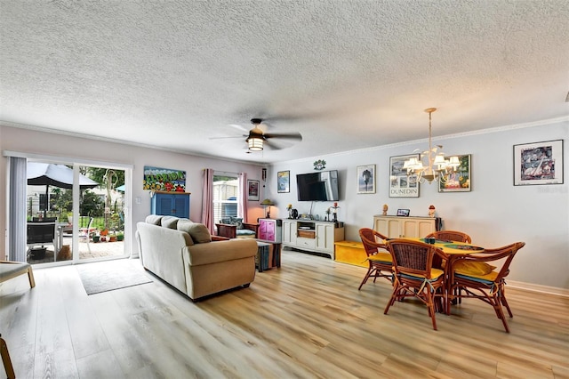 2700 Bayshore Blvd Unit 544, Dunedin, FL 34698 - living area featuring light wood-type flooring, a chandelier, a textured ceiling, ornamental molding, and a ceiling fan
