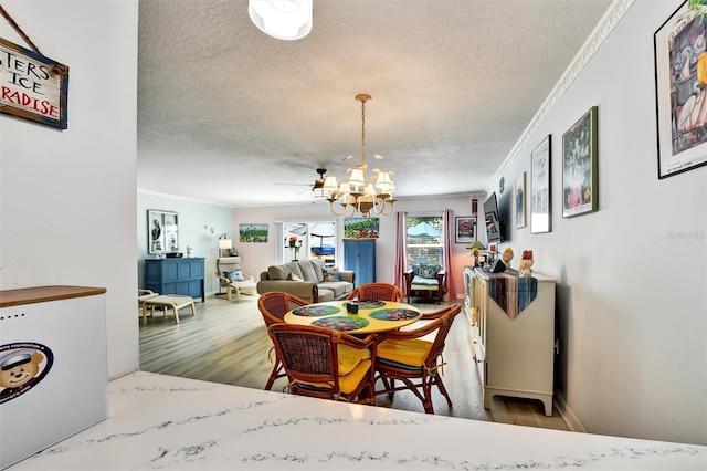 2700 Bayshore Blvd Unit 544, Dunedin, FL 34698 - dining space with a textured ceiling, a chandelier, wood finished floors, and ornamental molding