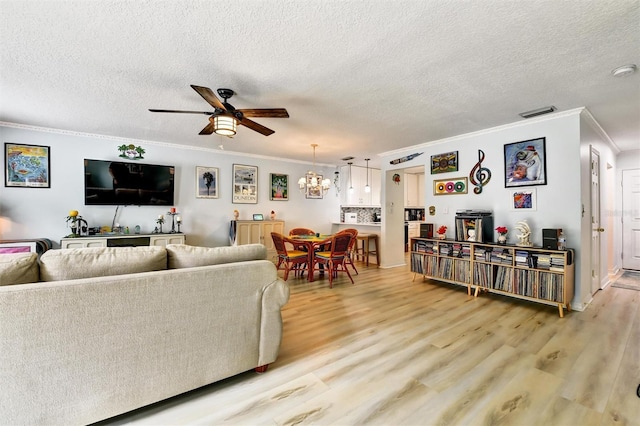 2700 Bayshore Blvd Unit 544, Dunedin, FL 34698 - living room with ornamental molding, a ceiling fan, light wood-type flooring, a textured ceiling, and a chandelier