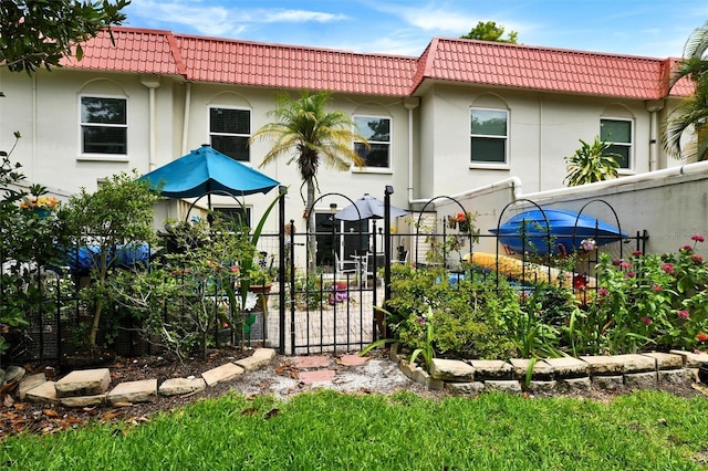 2700 Bayshore Blvd Unit 544, Dunedin, FL 34698 - back of property with a tile roof, stucco siding, and a gate