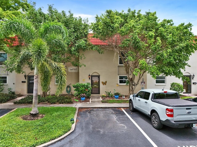 2700 Bayshore Blvd Unit 544, Dunedin, FL 34698 - view of front of house with stucco siding, uncovered parking, and a tiled roof