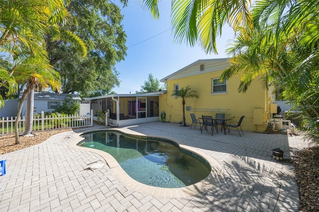 4521 S Cooper Pl, Tampa, FL 33611 - view of swimming pool with a sunroom and a patio area