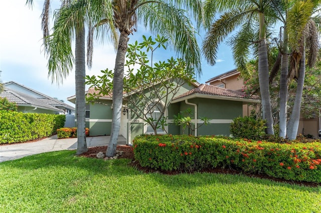 835 Symphony Isles Blvd, Apollo Beach, FL 33572 - view of front of house featuring stucco siding, a front yard, and a tile roof