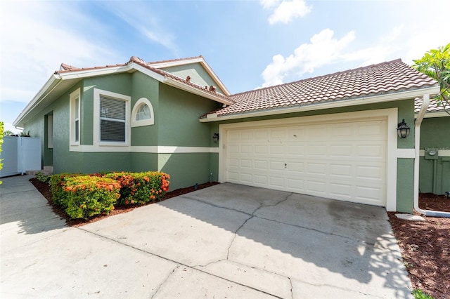 835 Symphony Isles Blvd, Apollo Beach, FL 33572 - mediterranean / spanish-style house with stucco siding, a garage, and driveway