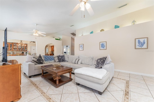 835 Symphony Isles Blvd, Apollo Beach, FL 33572 - living room featuring ceiling fan, arched walkways, inlaid floor details, light tile patterned floors, and high vaulted ceiling