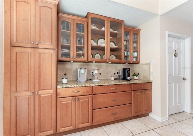 835 Symphony Isles Blvd, Apollo Beach, FL 33572 - bar area featuring tasteful backsplash, light tile patterned floors, and a textured ceiling