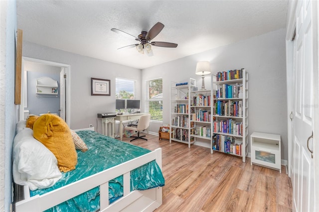 835 Symphony Isles Blvd, Apollo Beach, FL 33572 - bedroom with wood finished floors, a textured ceiling, and a ceiling fan