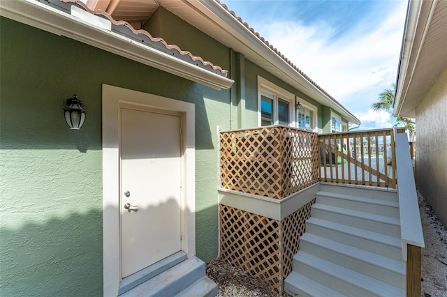 835 Symphony Isles Blvd, Apollo Beach, FL 33572 - view of exterior entry with stucco siding and a tile roof