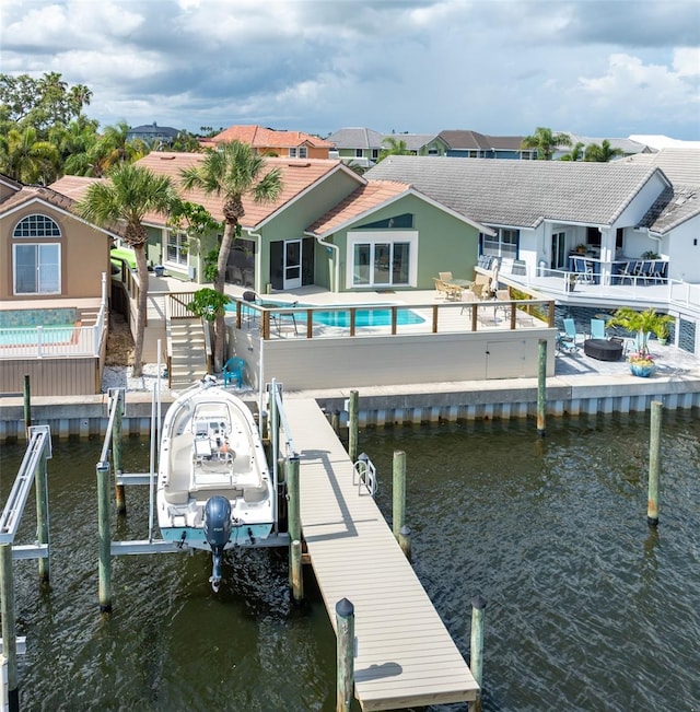 835 Symphony Isles Blvd, Apollo Beach, FL 33572 - dock area with boat lift, an outdoor pool, and a water view