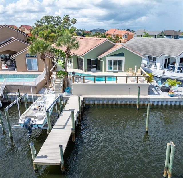 835 Symphony Isles Blvd, Apollo Beach, FL 33572 - dock with a water view, an outdoor pool, a fenced backyard, boat lift, and a residential view