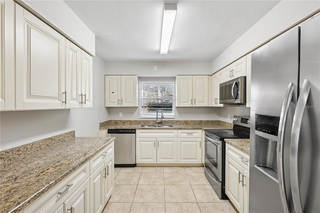 129 Magnolia Ave, Seffner, FL 33584 - kitchen featuring stainless steel appliances, light stone counters, white cabinets, and light tile patterned floors