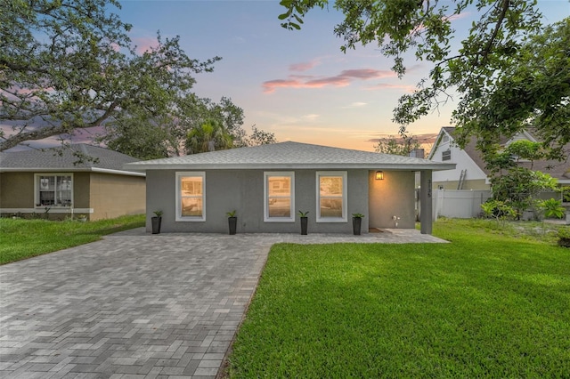 3135 W Varn Ave, Tampa, FL 33611 - ranch-style house featuring stucco siding, driveway, and roof with shingles