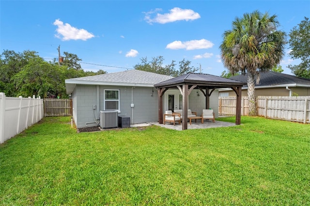 3135 W Varn Ave, Tampa, FL 33611 - back of house featuring a fenced backyard, concrete block siding, a gazebo, a patio area, and a shingled roof