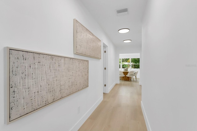 3381 19th Pl SW, Largo, FL 33774 - hallway featuring light wood-style flooring and baseboards