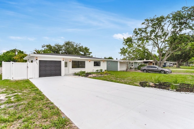 3381 19th Pl SW, Largo, FL 33774 - view of front facade featuring an attached garage and concrete driveway