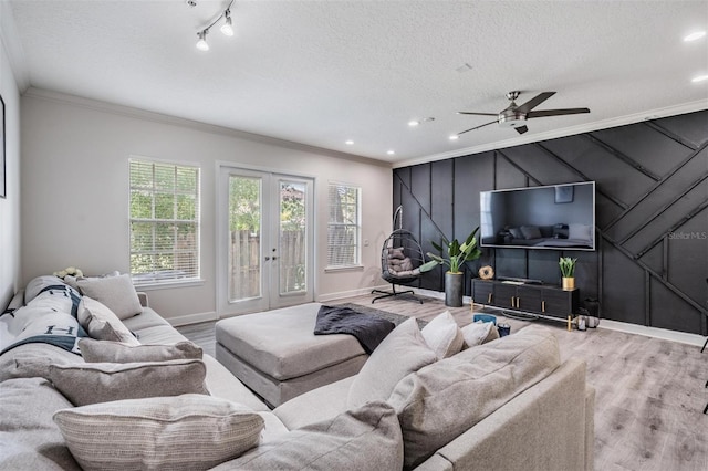 3210 W Horatio St Unit 9, Tampa, FL 33609 - living room with crown molding, wood finished floors, french doors, a decorative wall, and ceiling fan